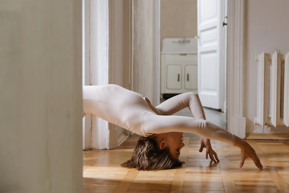 Woman performing a challenging balance yoga pose indoors